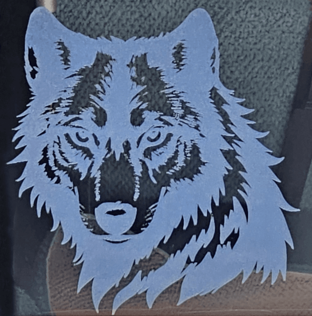 Wolf Engraved on Mirror  with Monport Onyx on Blue Backing.